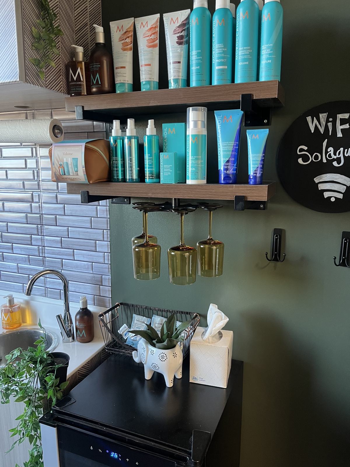 Moroccanoil products on the suite shelves above the shampoo sink