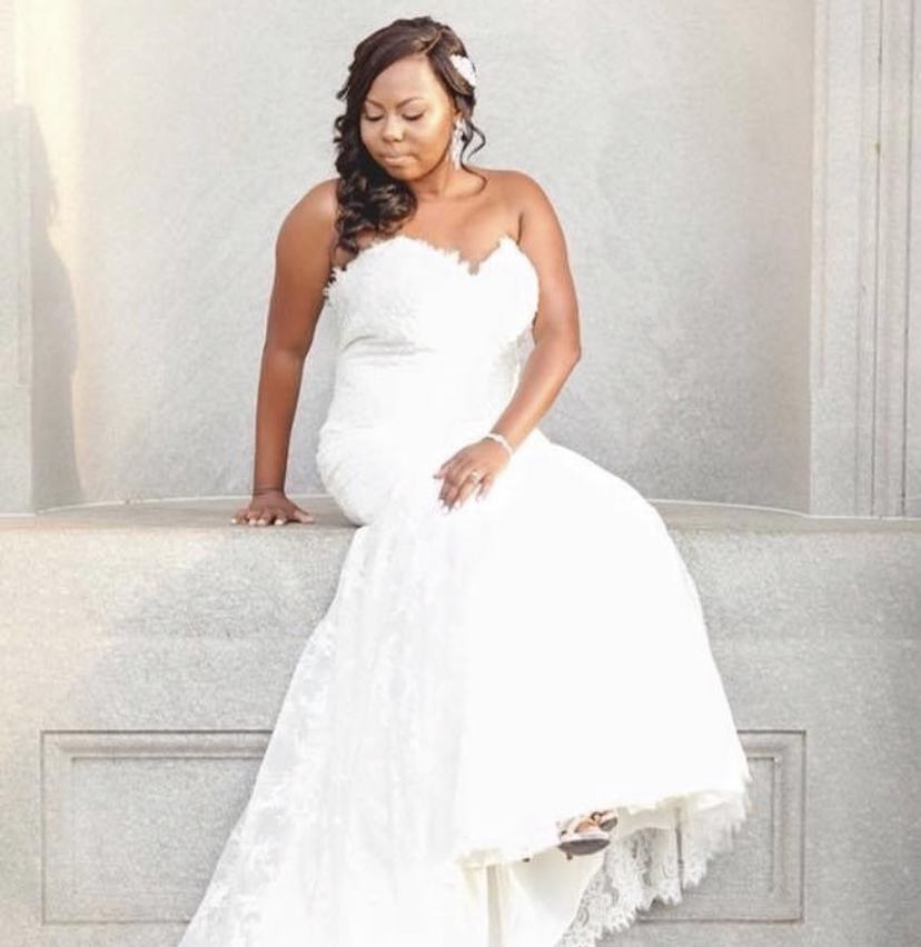A bride in a white gown with her hair styled
