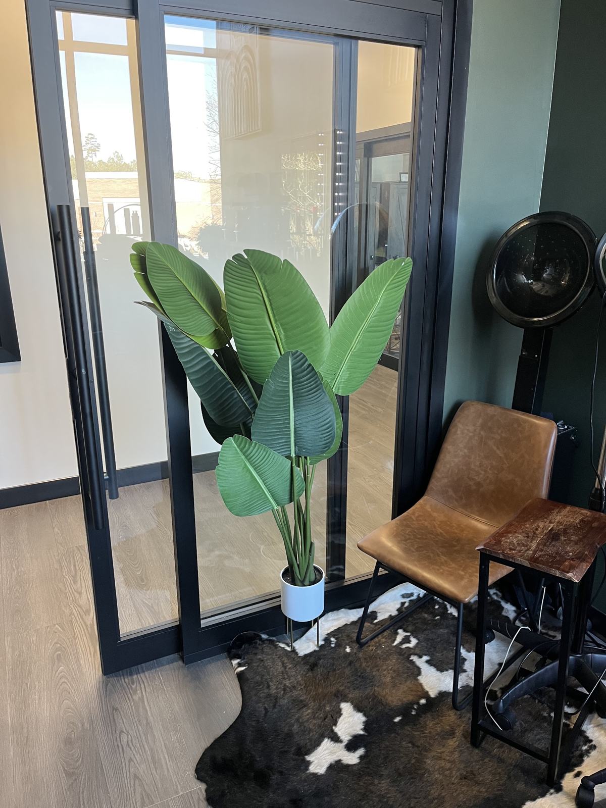 The suite entrance with a leather chair and a tall plant