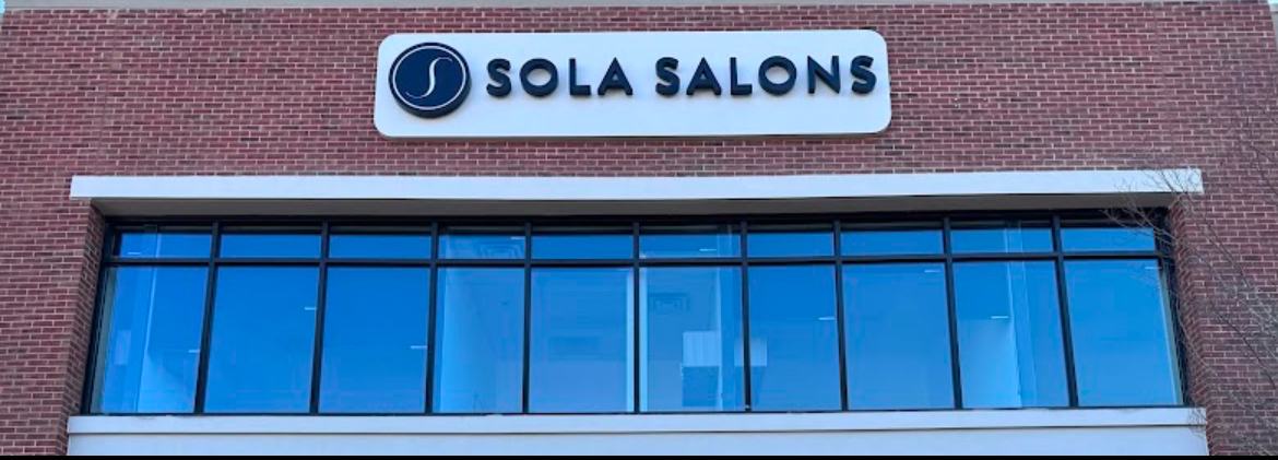 The Sola Salons sign on the building